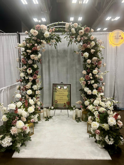 Wedding Expo booth highlighting pink and white arch and aisle pices on display